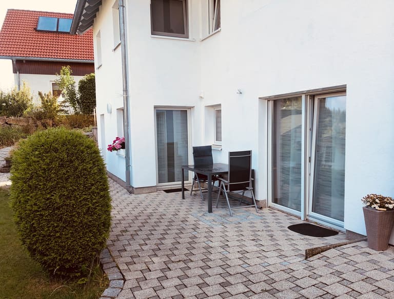 Private terrace with garden table and chairs directly outside the apartment
