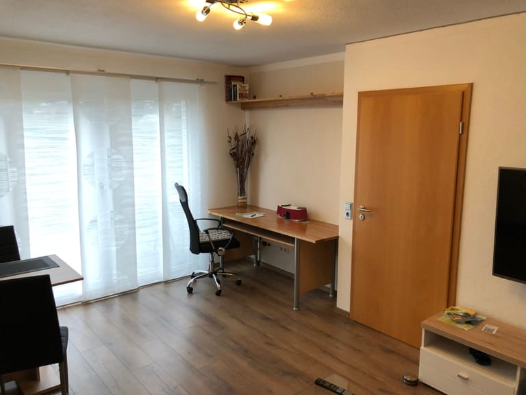 Work space with a desk and office chair next to the terrace door